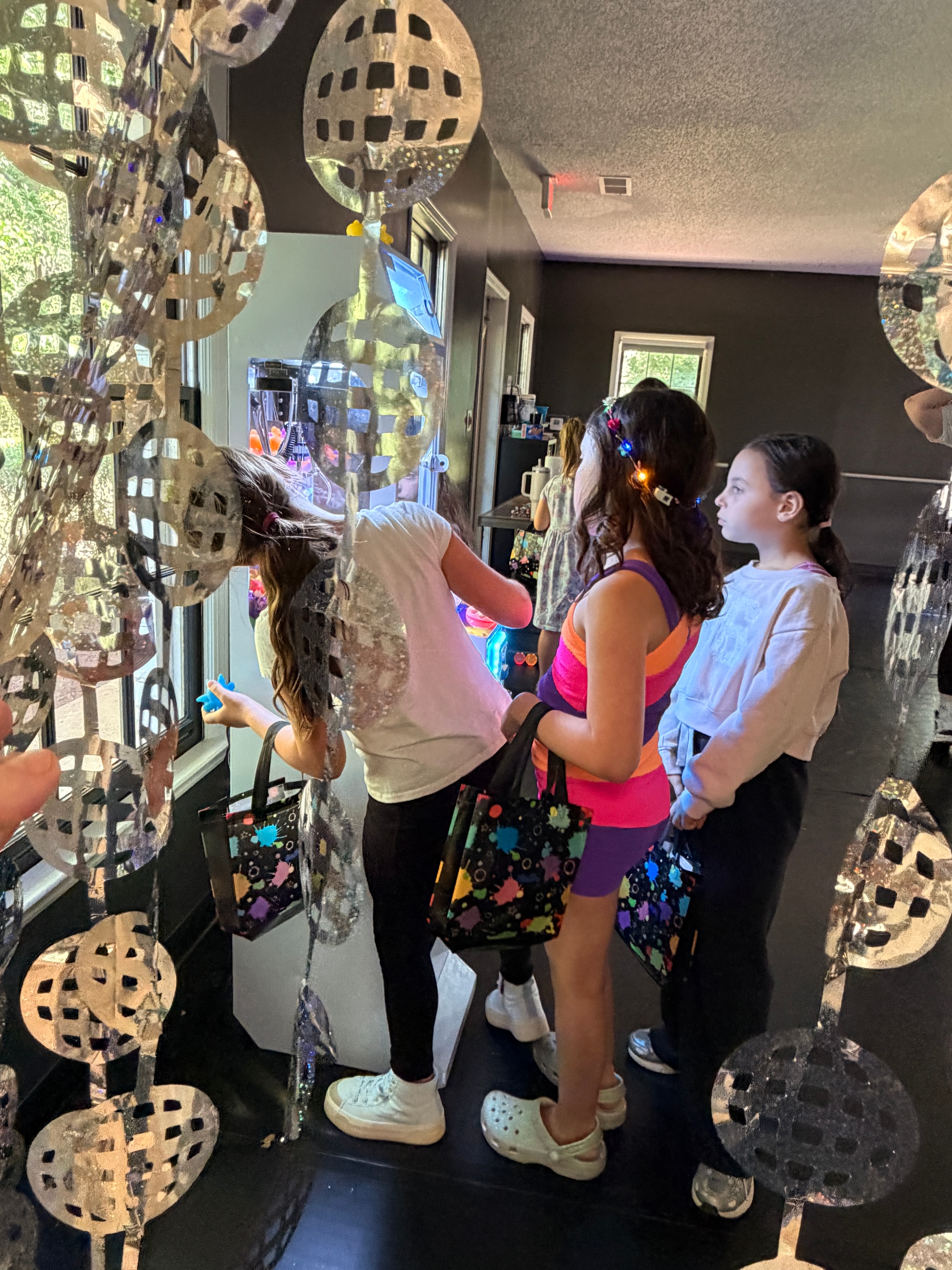 Kids playing the crane game at a birthday party