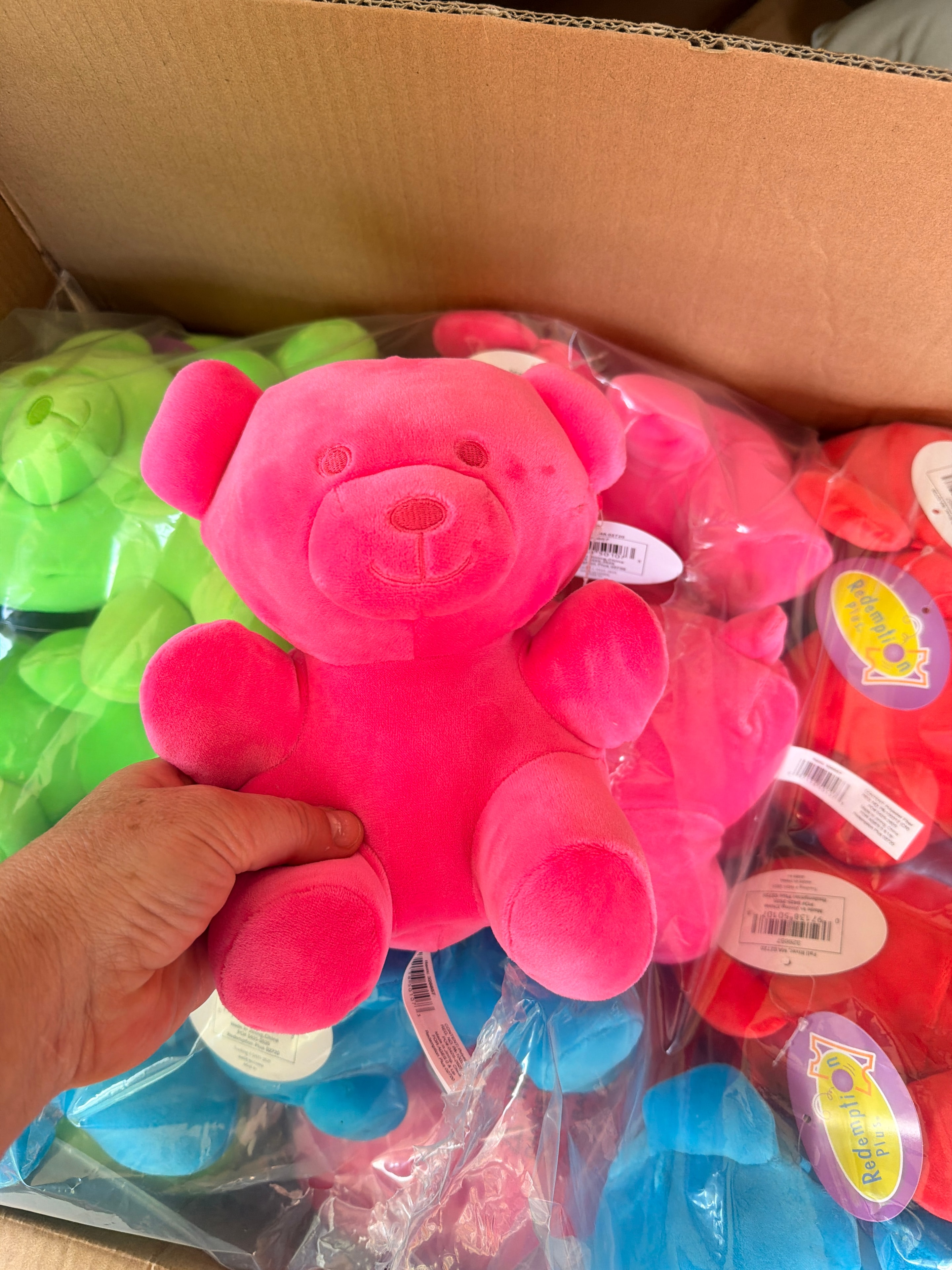Colorful plush bear prizes in a box